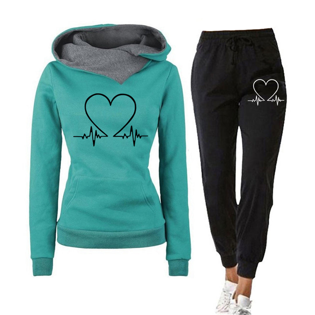 Stylish women's relaxed fit tracksuit in black with a white heart graphic, trendy casualwear set including a hoodie and joggers.