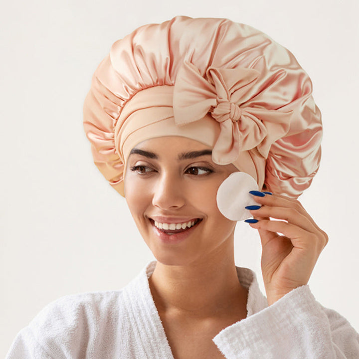 Collection of various colored silk satin sleepcaps for women, offering reversible wear