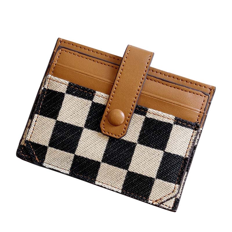Front flap closure detail of the women's compact wallet, plaid and colorblock design