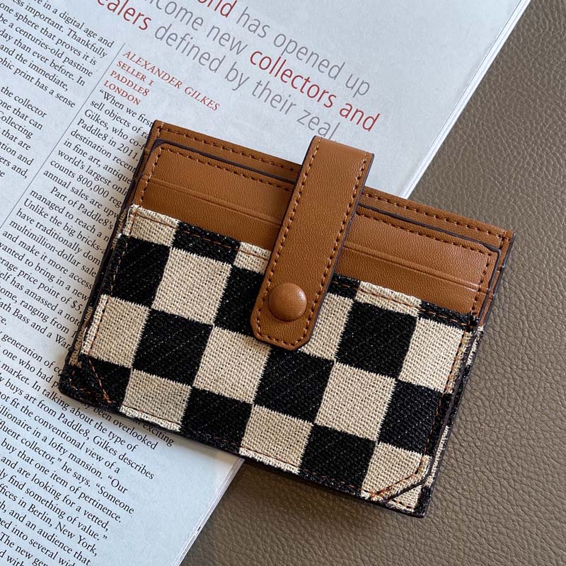 Side profile of women's compact wallet, highlighting its slim design despite being a zipper walet