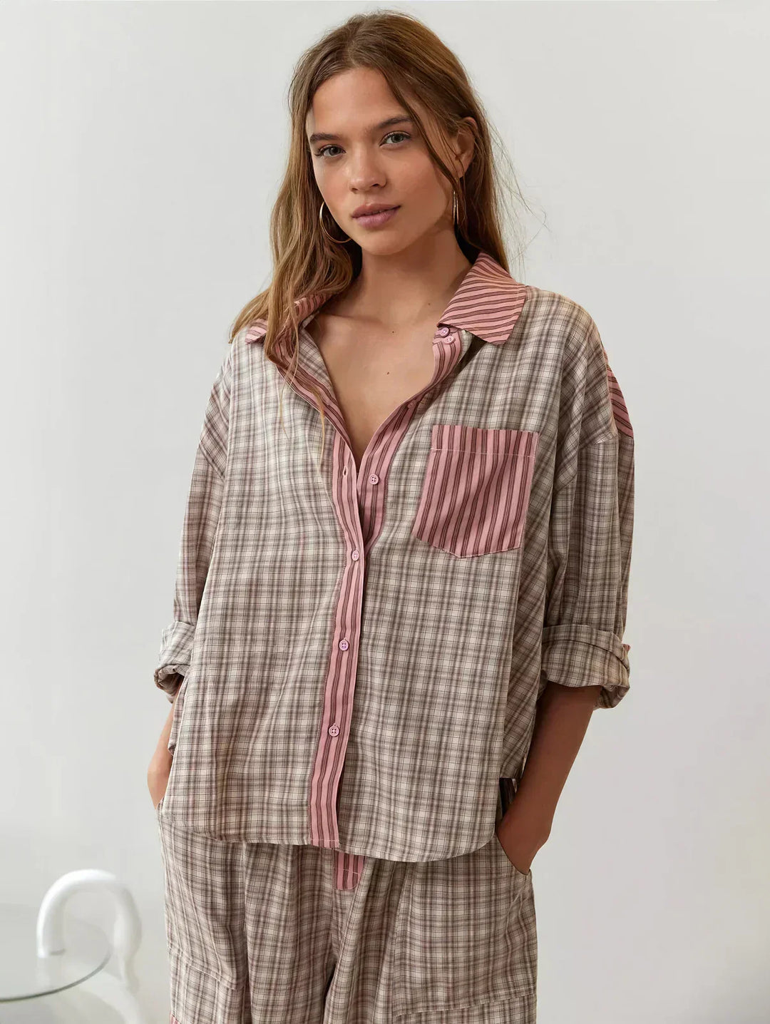 Women's plaid pajama set, cozy button-up long-sleeve top & relaxed fit pants for comfortable sleep.