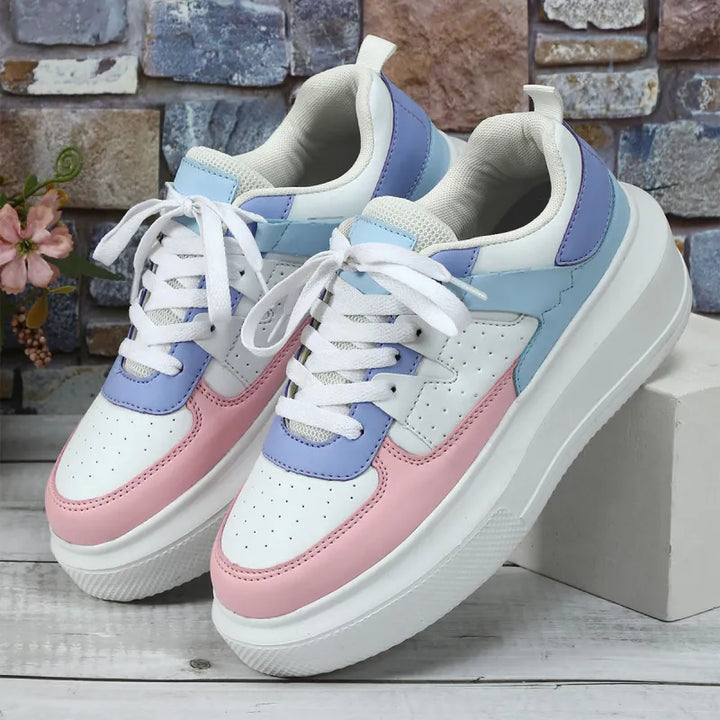 Fashion-forward women's platform sneakers with intricate perforated details & secure lace-up closure. Modern footwear.