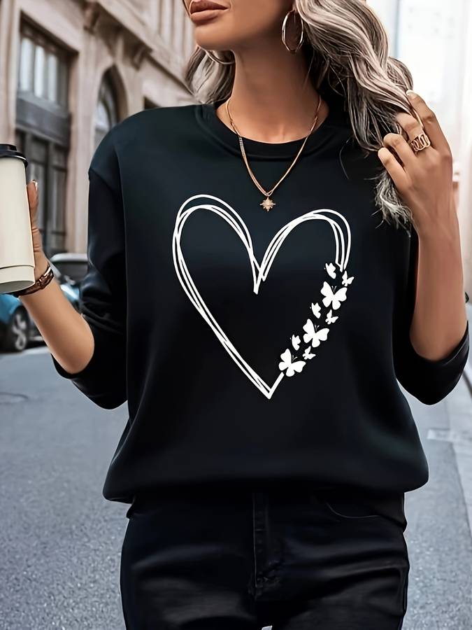 Women's playful heart print pullover sweater. Soft, long-sleeve top for casual everyday style and comfort.