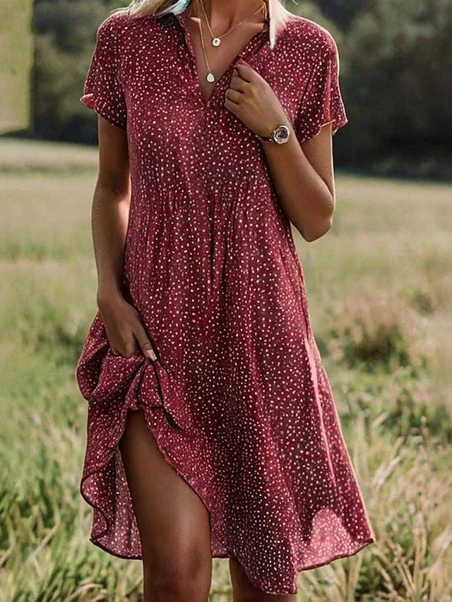 Comfortable women's polka dot summer dress; a playful, knee-length A-line v-neck with short sleeves for versatile everyday style.
