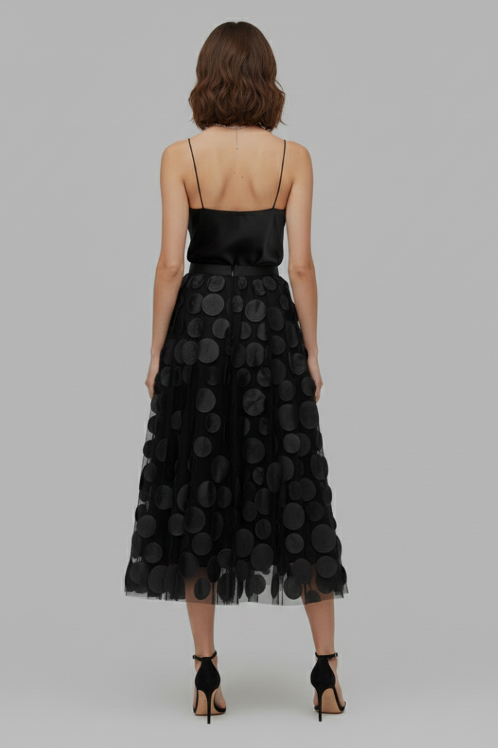 Flowing women's polka dot full midi skirt. Playful and elegant fashion for a chic look.