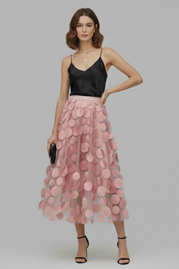 Stylish woman wearing a playful polka dot full midi skirt, showcasing modern women's fashion.