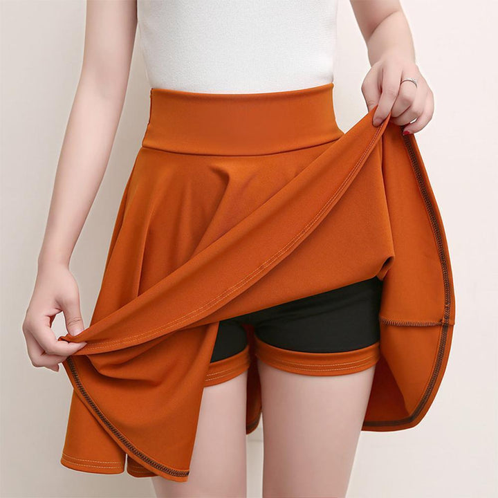 Model wearing a black pleated A-line skort, elastic waist, casual comfy style