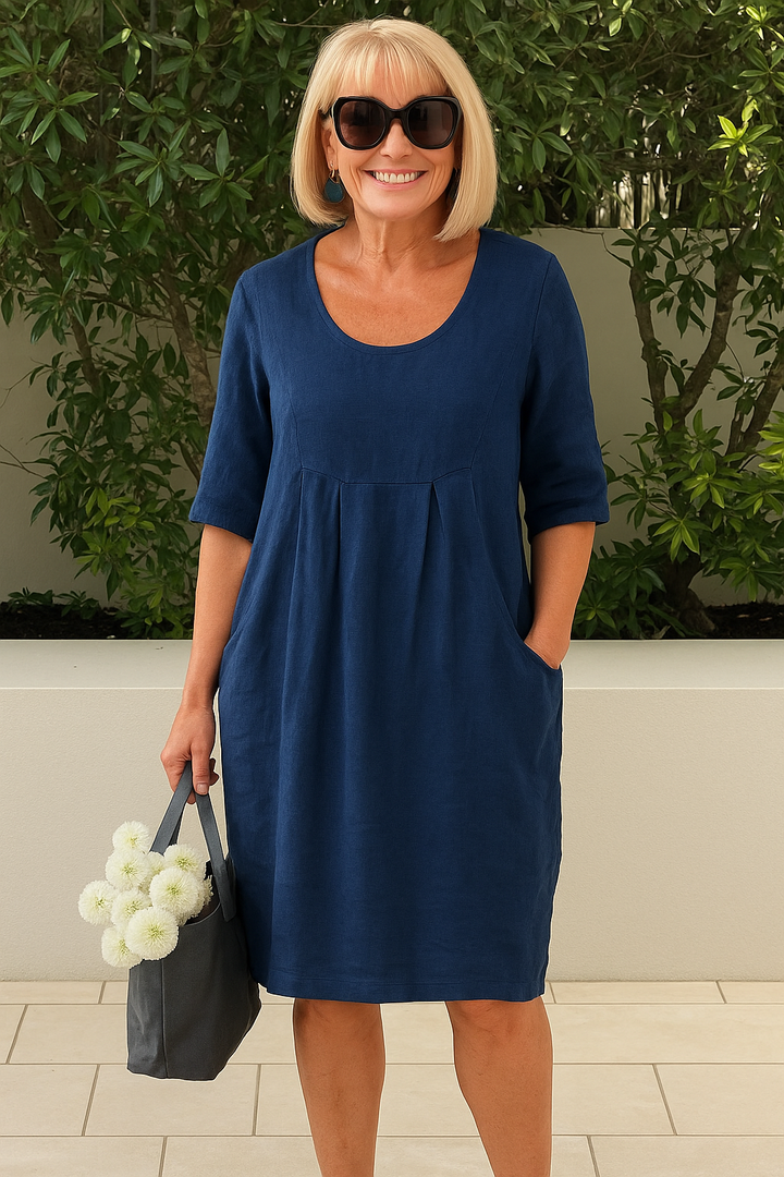 Elegant women's A-line midi dress with pleated bust & pockets. Comfortable scoop neck and elbow sleeves for versatile style.