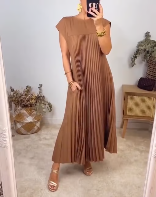 Flowy women's maxi dress, pleated design, extended cap sleeves, comfortable empire waist.