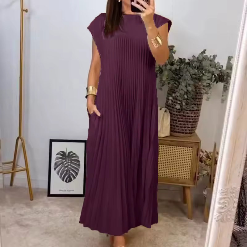 Women's long pleated maxi dress with extended cap sleeves & relaxed empire waist. Chic & comfy.