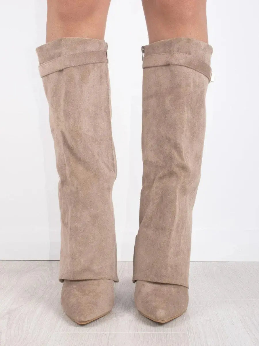 Close-up of the comfortable wedge heel on women's knee-high boots, stylish and supportive.