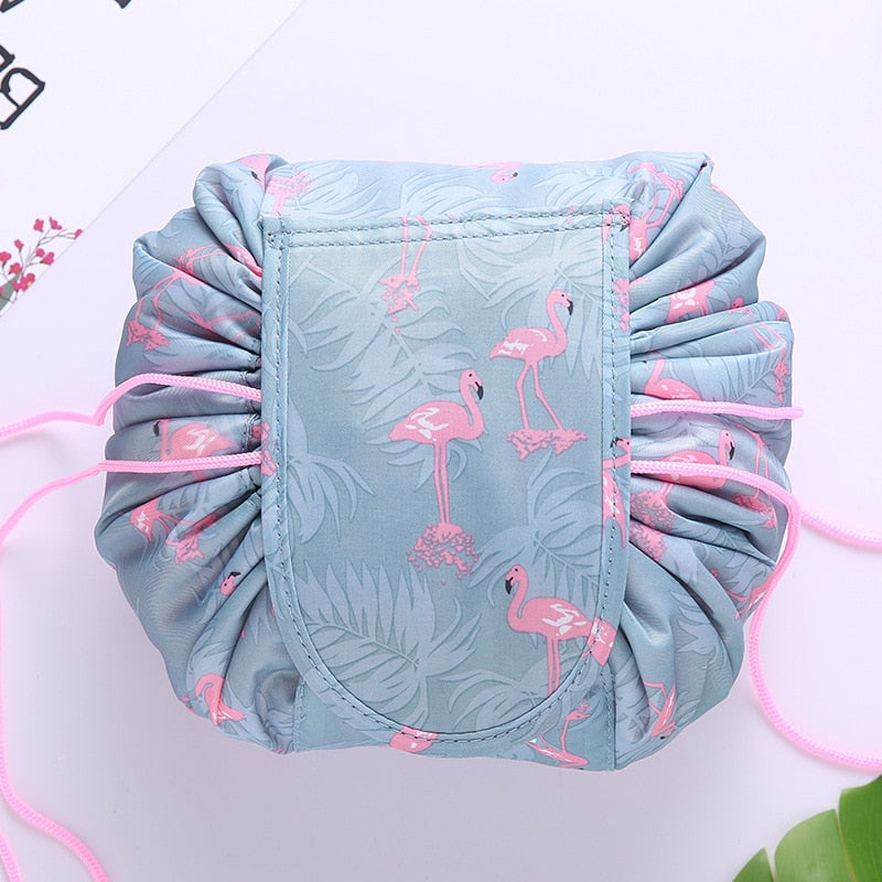 Open drawstring cosmetic bag interior with makeup & toiletries, organized women's travel organizer.