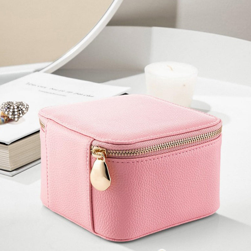Compact leather jewelry travel case in blush, ideal for women's on-the-go accessory storage