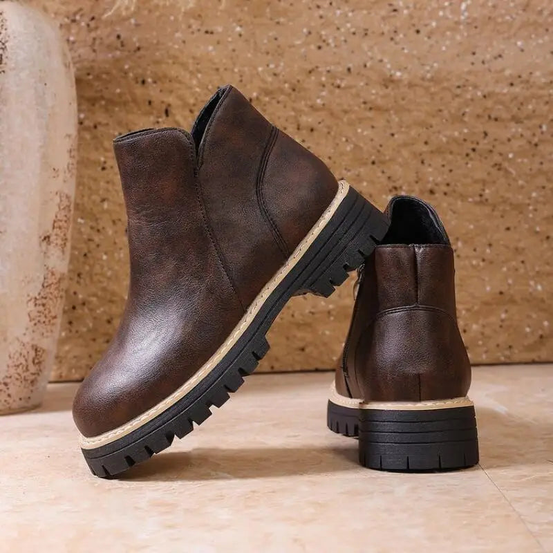 Stylish women's leather ankle boots with a prominent lug sole, perfect for comfortable winter wear.