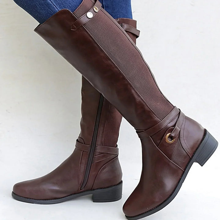 Orthopedic women's black leather boots, ankle height, offering comfort and support for casual winter outfits.