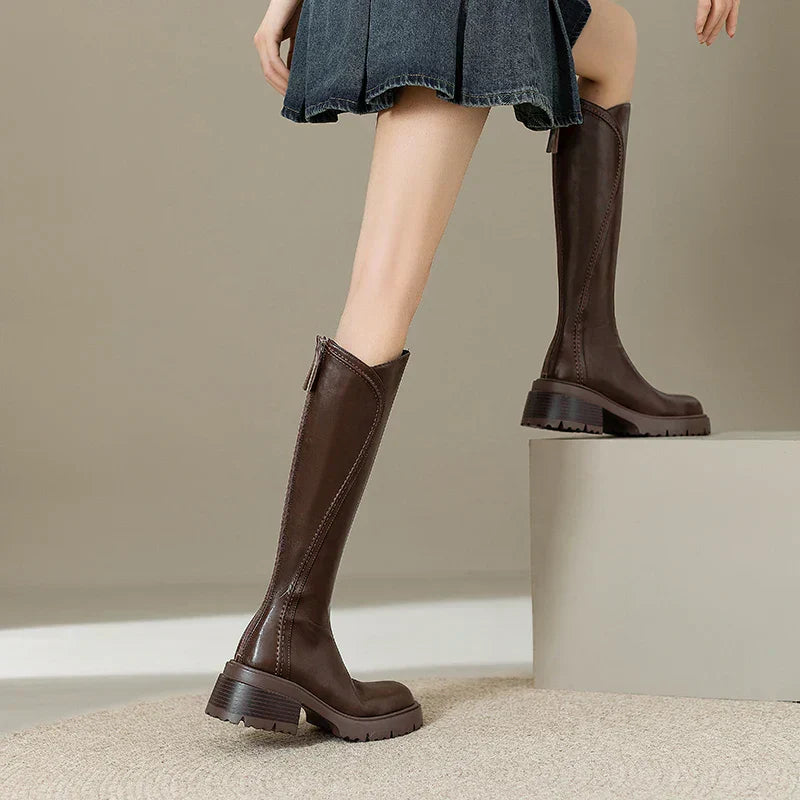 Pair of comfortable women's knee-high orthopedic leather boots, ready for cold weather.