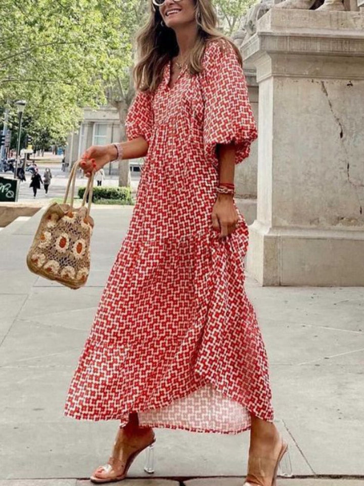 Women's printed maxi dress with a flattering waistband, perfect for elegant summer fashion.