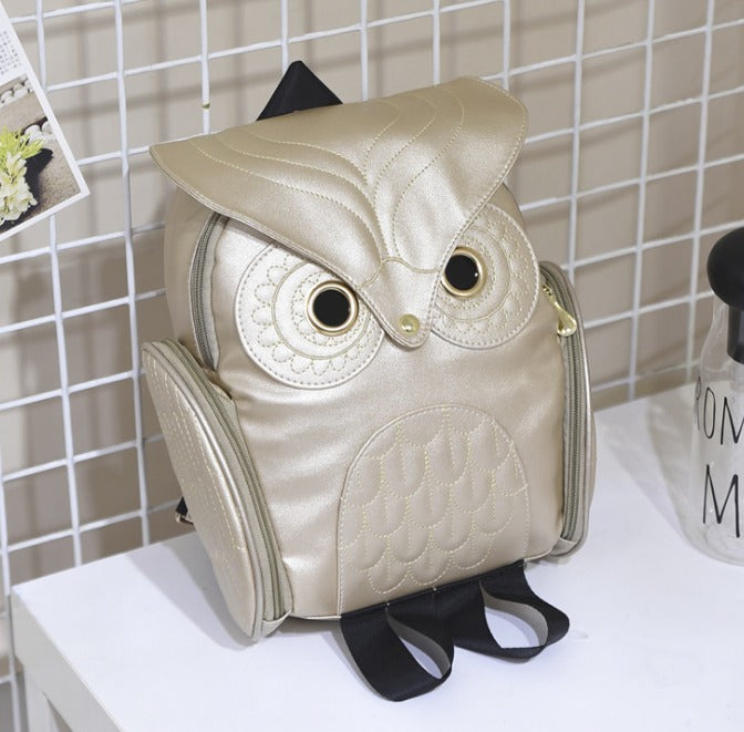 Side profile of a women's stylish PU leather owl print backpack, compact yet spacious.