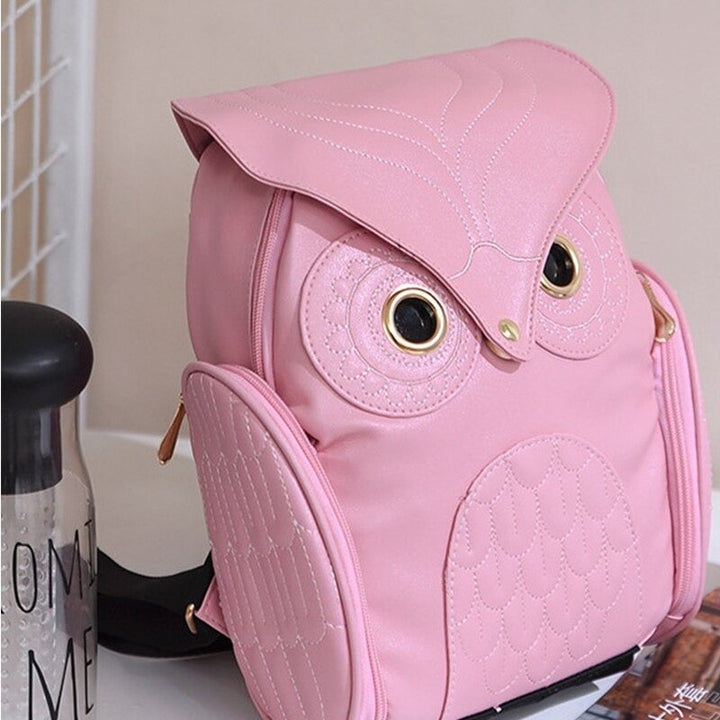 Front view: Women's fashion backpack, PU leather with vibrant owl print & multiple pockets.