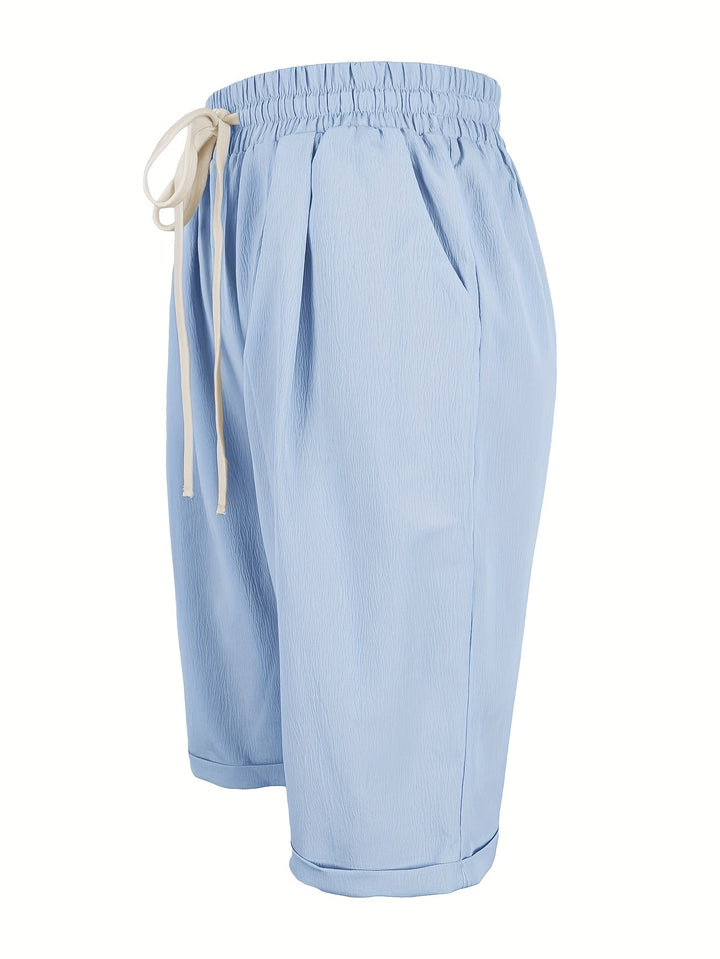 Close-up of comfortable elastic waist on women's pull-on straight leg cropped shorts, relaxed fit.