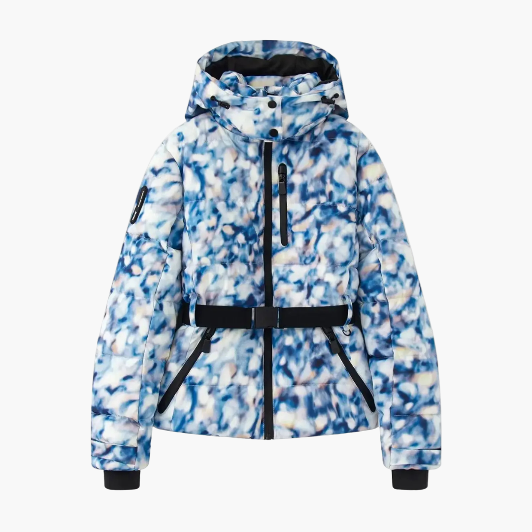 Woman posing confidently in a fashion-forward hooded and belted quilted outerwear piece