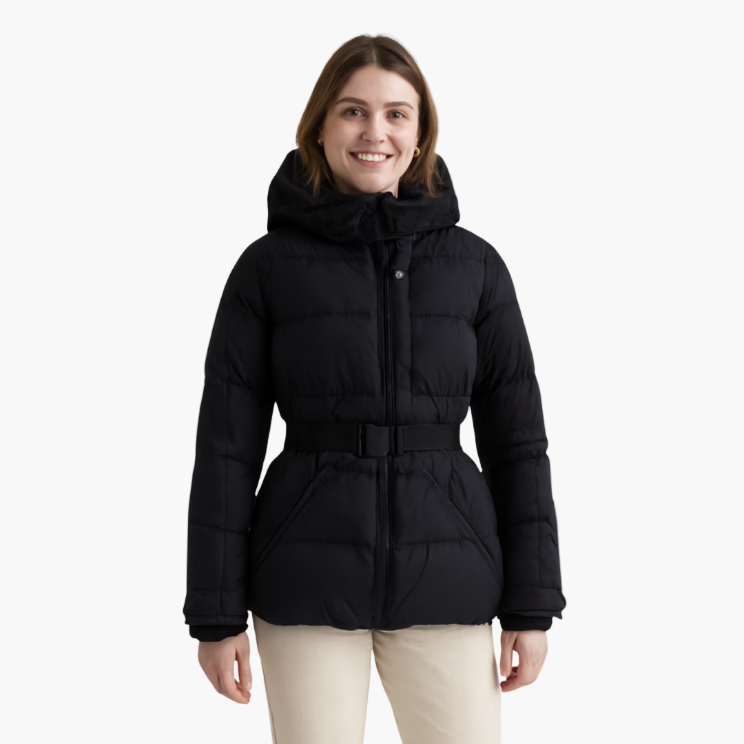 Woman zipping up her hooded, belted, quilted winter coat, showing front closure