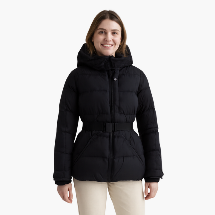 Woman zipping up her hooded, belted, quilted winter coat, showing front closure