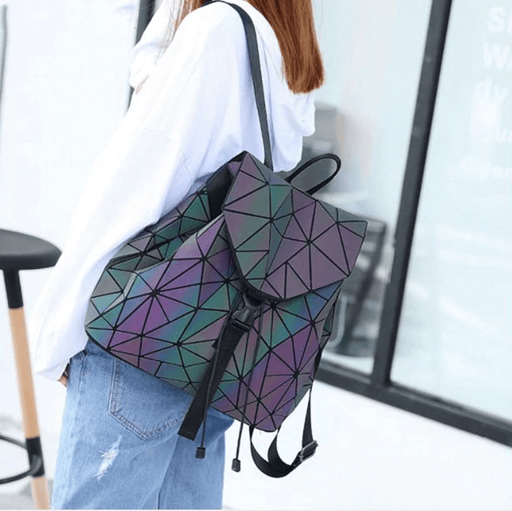 Modern women's faux leather backpack, geometric and reflective, showing its vibrant color-changing effect.