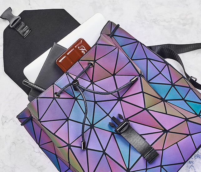 Stylish women's travel backpack with reflective geometric panels and color-changing visual effect.
