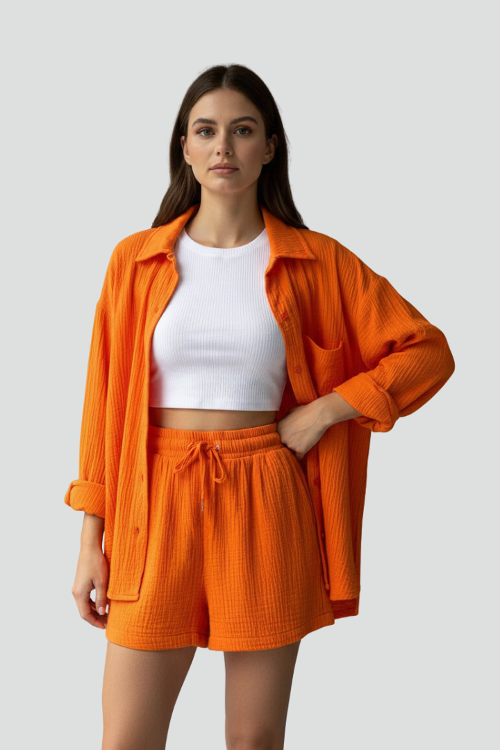 Soft women's loungewear set featuring a relaxed button-up shirt and drawstring shorts. Perfect comfort.