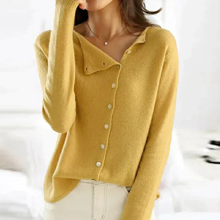 Light colored women's relaxed fit button-front cardigan, versatile knitwear for a chic winter look.