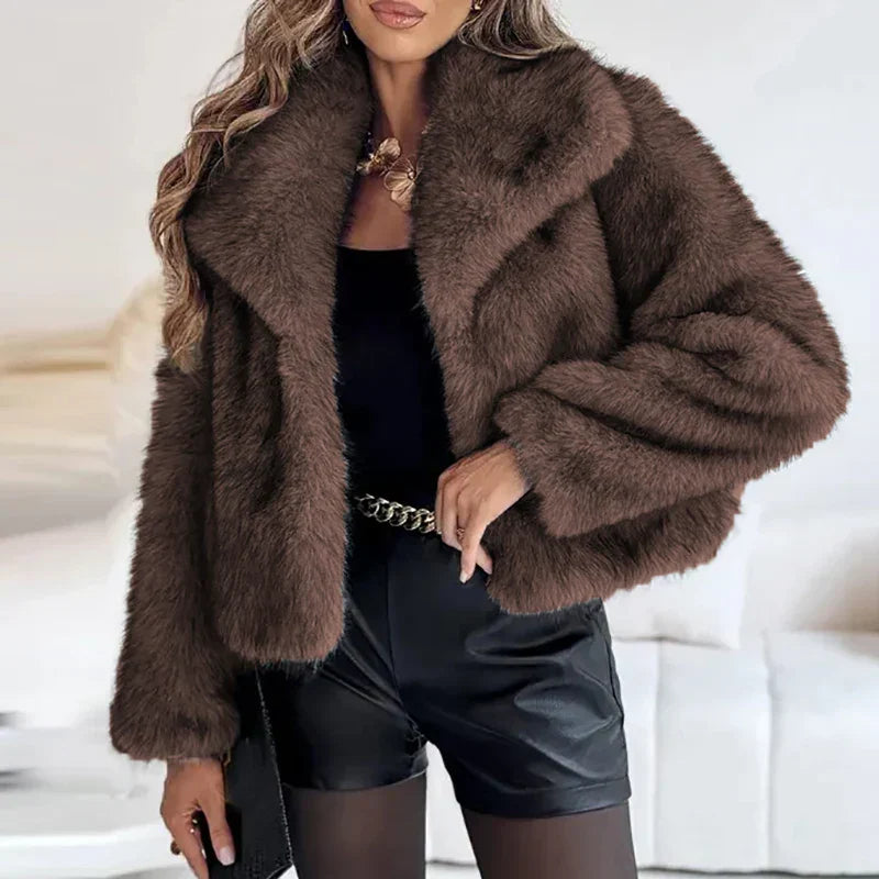 Studio shot of a women's cream-colored relaxed fit faux fur jacket, a plush winter essential