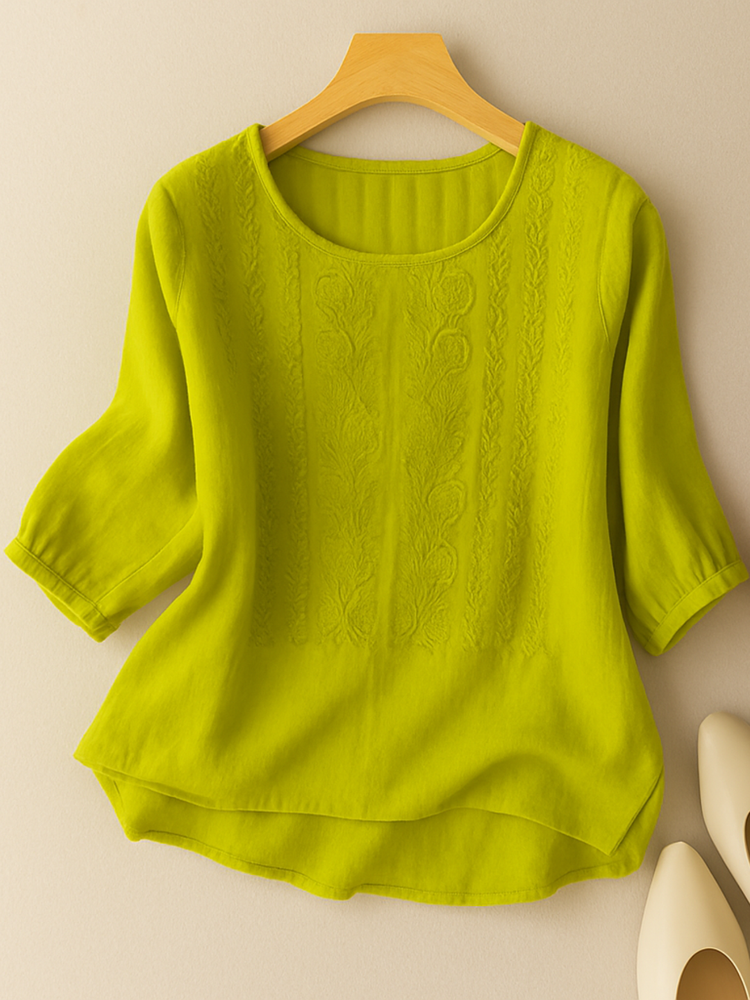 Casual women's three-quarter sleeve embroidered top with a relaxed fit, great for warm weather fashion.