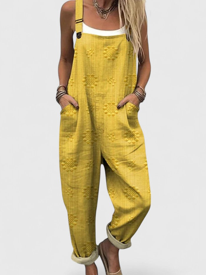 Model wearing a comfortable women's relaxed fit floral embroidered jumpsuit with pockets, ideal for everyday casual wear.