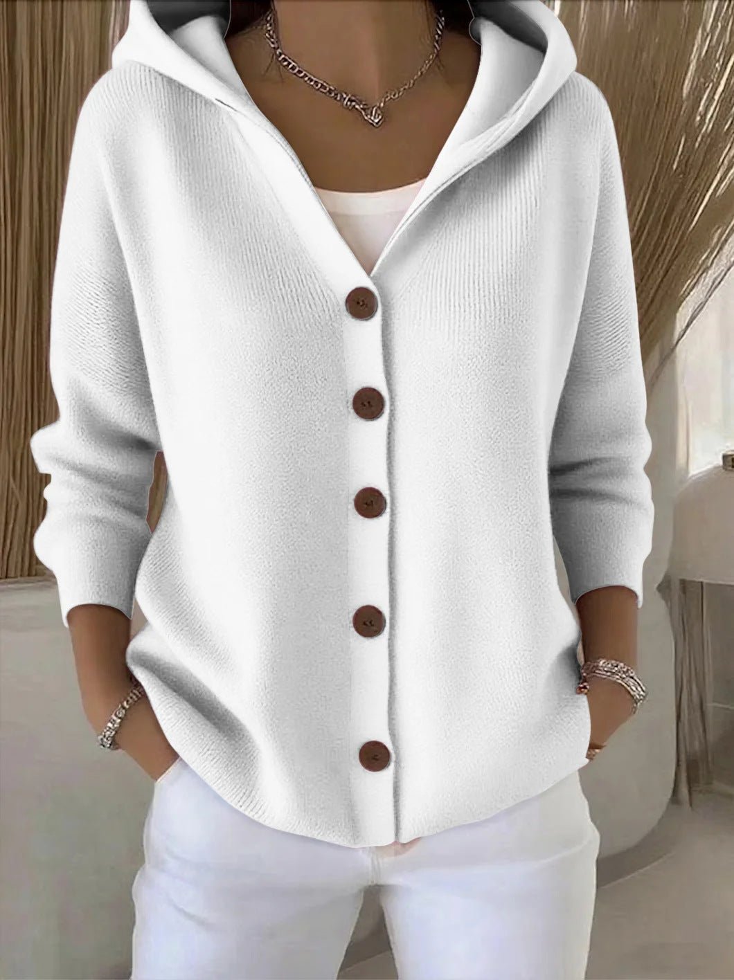Model wearing a women's relaxed fit hooded button-front cardigan sweater for a cozy fall look.
