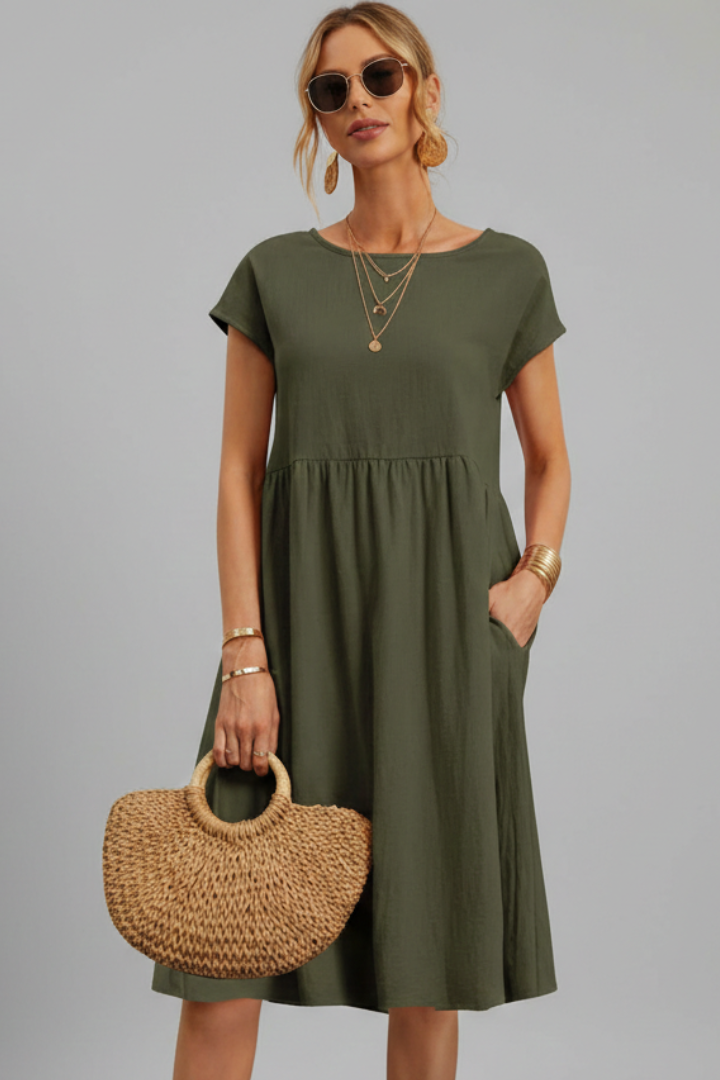 Short sleeve women's knee-length dress, relaxed fit with a round neck, pockets, and a comfortable feel.