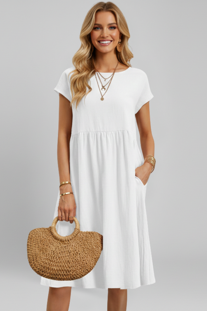 Versatile women's summer dress, knee-length, relaxed fit, featuring a round neck, short sleeves, and pockets.