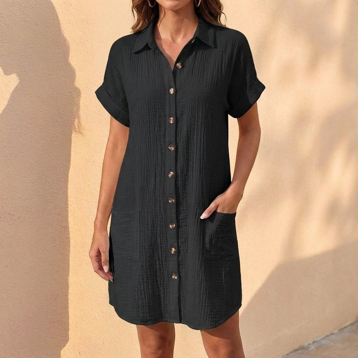 Woman wearing a comfortable relaxed fit midi shirt dress, styled for a casual day out. Versatile summer dress.