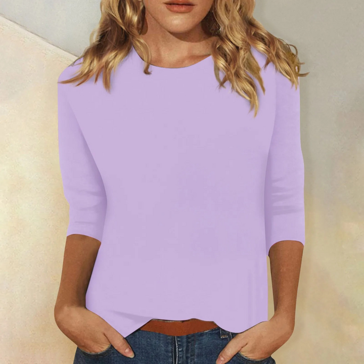 White women's casual round neck top with 3/4 sleeves. Versatile relaxed fit for effortless everyday style.