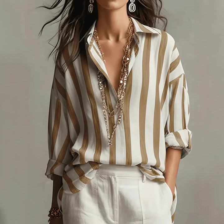 Striped button-down shirt for women. Relaxed fit, long-sleeve, versatile casual wear top for any occasion.