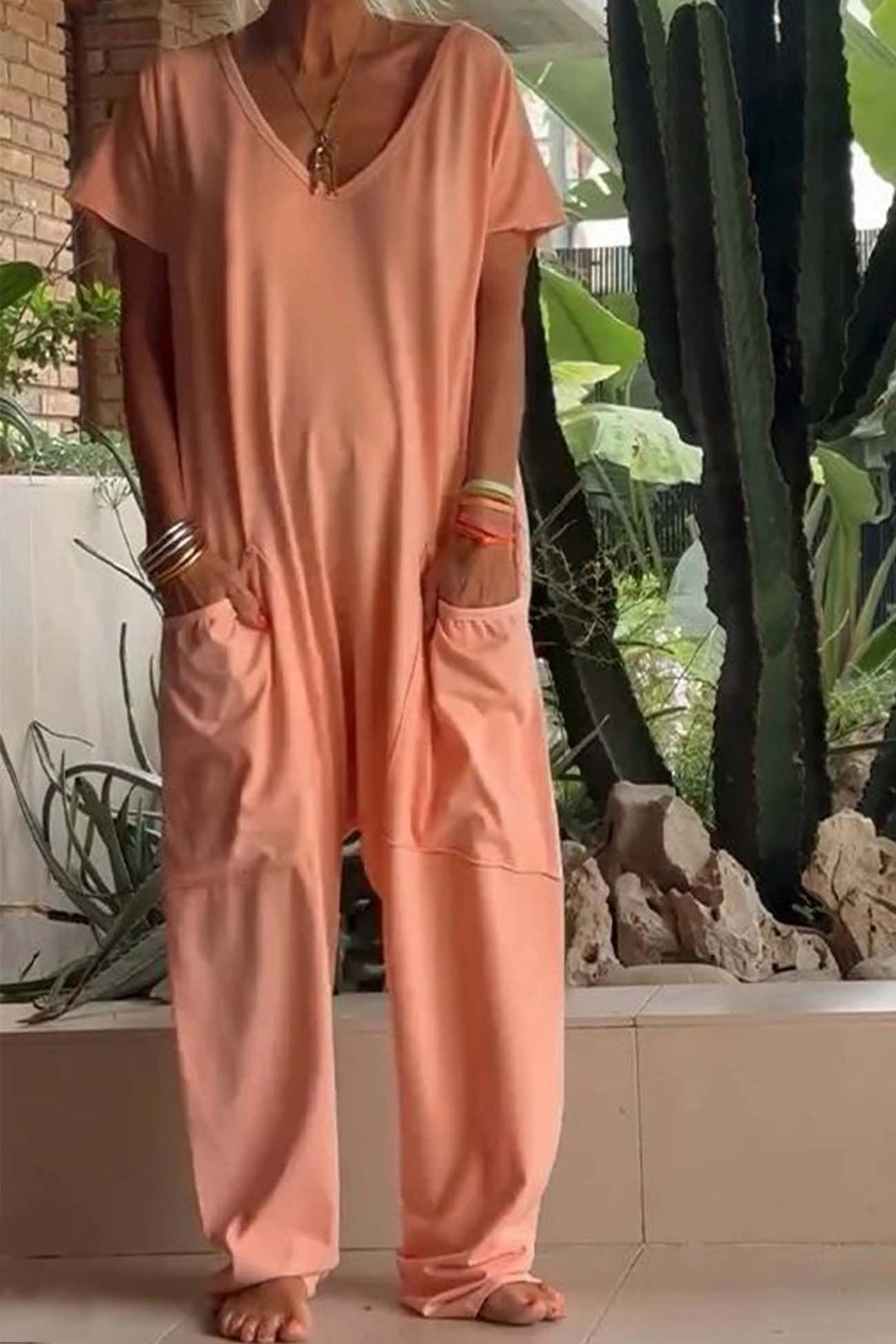 Versatile women's V-neck short sleeve dropped crotch jumpsuit, great for casual outings, loungewear or travel.