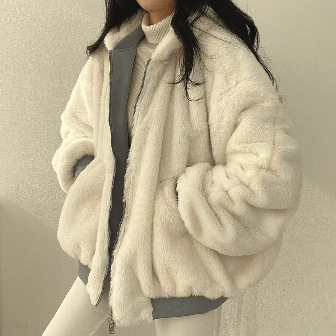 Front view of a women's warm winter coat, light blue, emphasizing its oversized and comfortable fit.