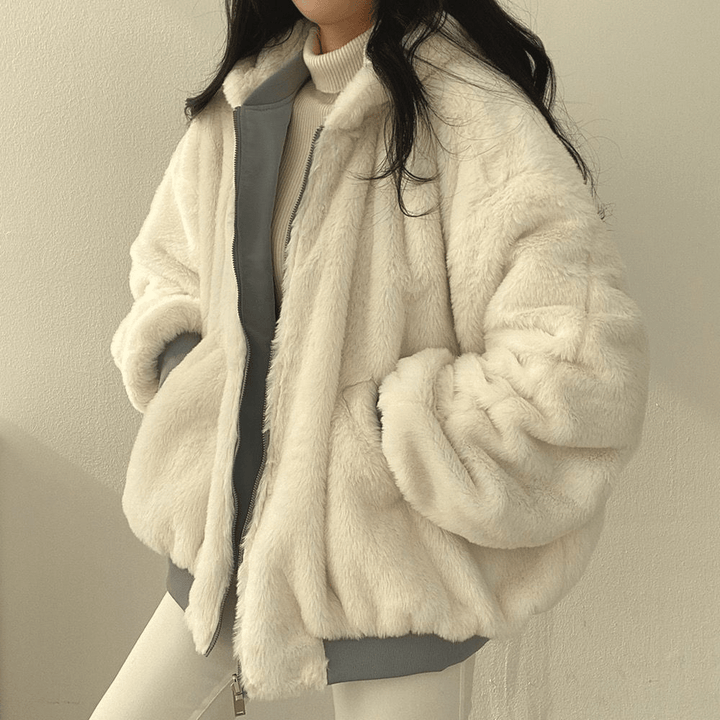 Front view of a women's warm winter coat, light blue, emphasizing its oversized and comfortable fit.