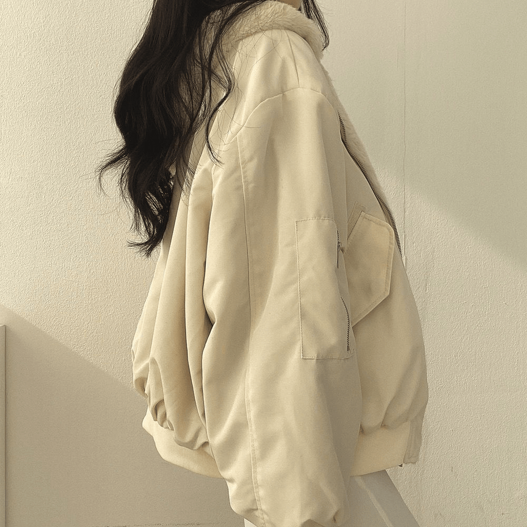 Close-up of the zipper detail on a women's relaxed fit warm winter jacket, silver hardware.