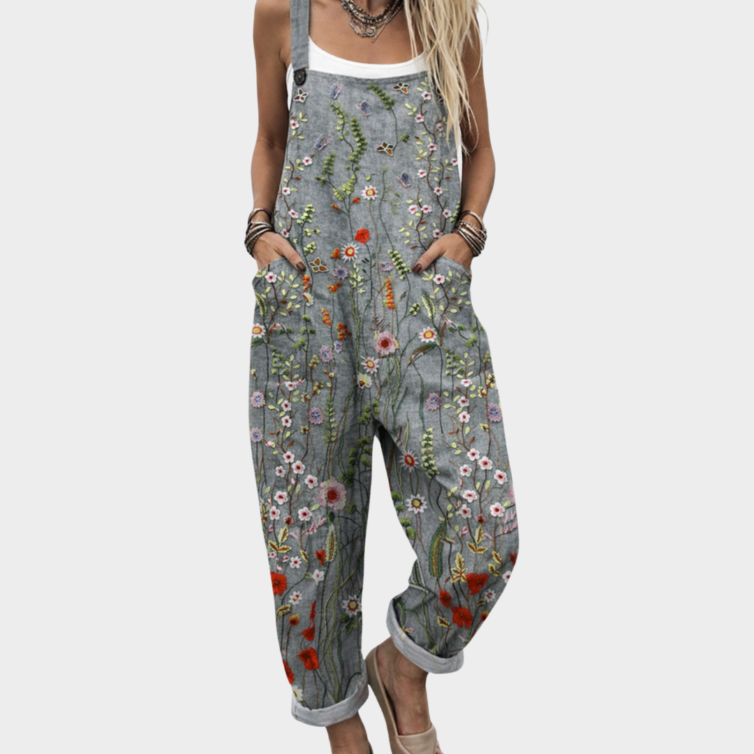 Women's relaxed fit wildflower meadow print dungaree jumpsuit with adjustable straps & pockets, perfect for summer.