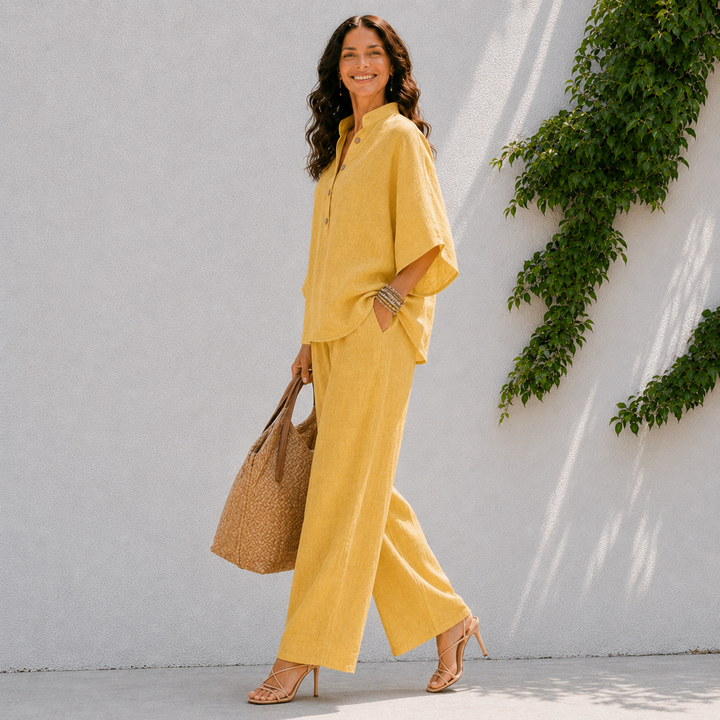 Stylish women's vacation outfit: comfortable two-piece set with oversized blouse & wide leg pants for travel.