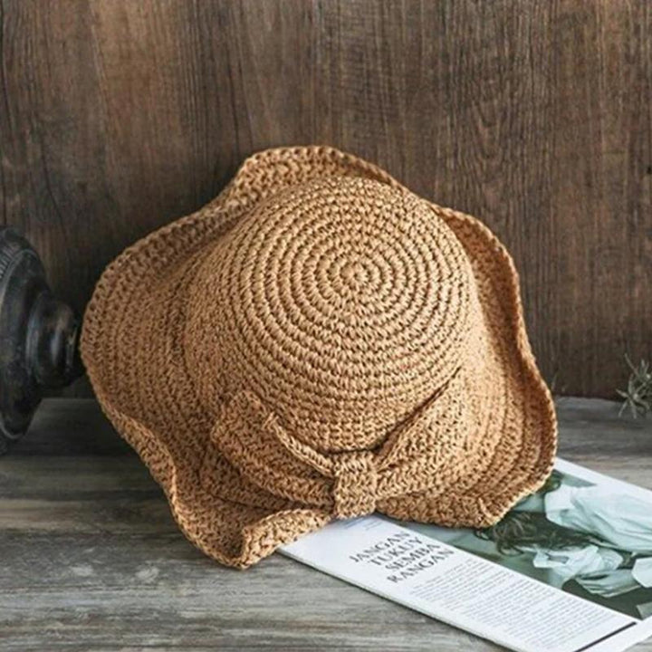 Women's summer fashion hat: wide brim, tasteful bow, excellent for sun and beach comfort