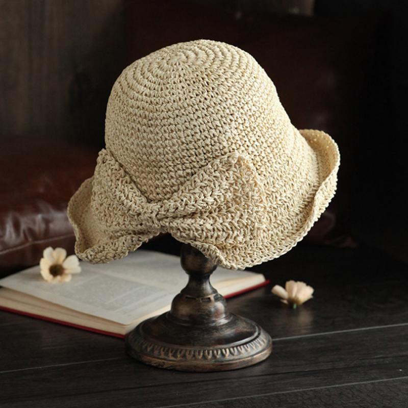 Classic wide-brim sun hat for women, featuring a chic bow, ideal for summer accessorizing