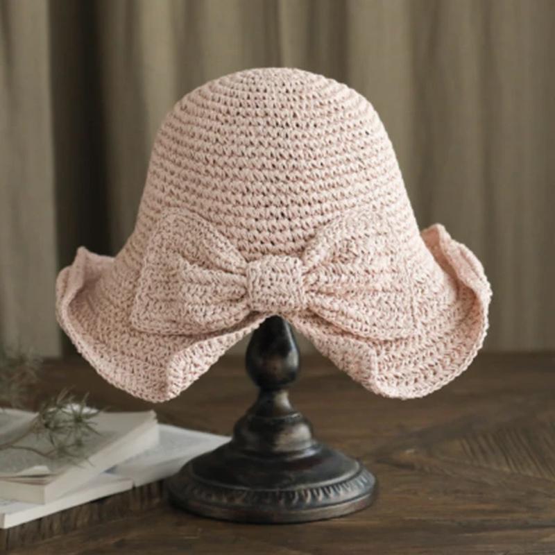 Retro wide-brim sun hat with a decorative bow, offering excellent UV protection for ladies