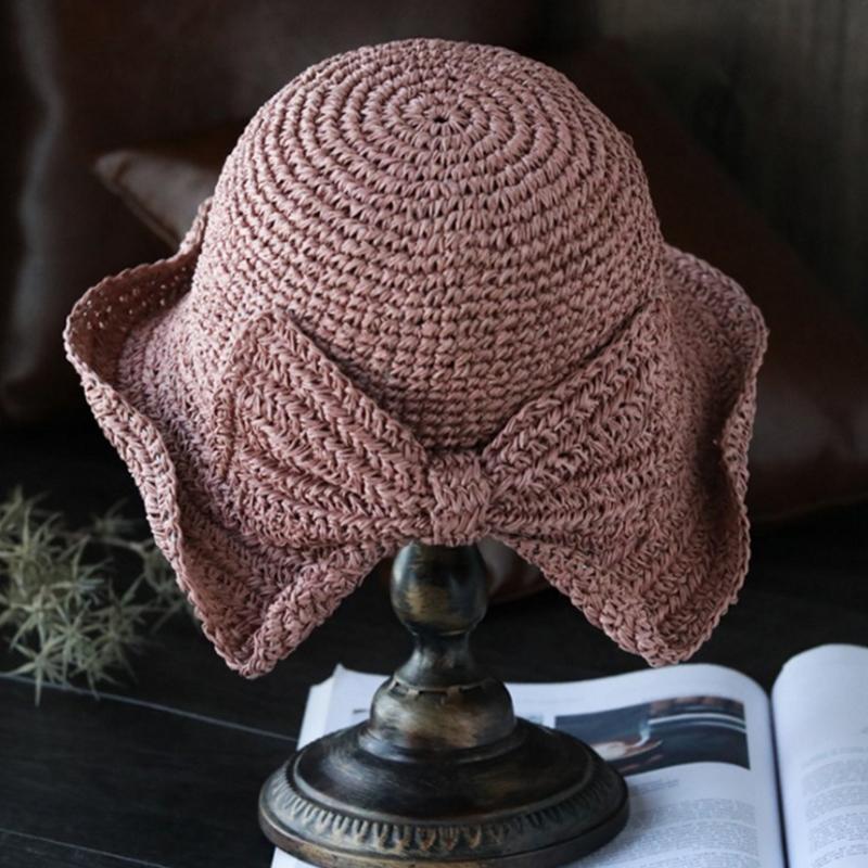 Vintage-inspired women's wide-brim sun hat with a beautiful bow, a summer beachwear must-have